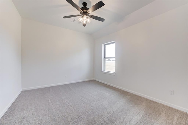 spare room featuring carpet and ceiling fan