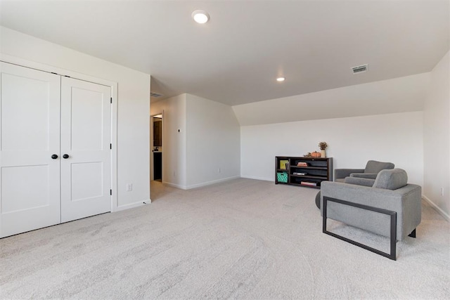 sitting room featuring light carpet and lofted ceiling