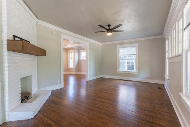 unfurnished living room with ornamental molding, dark hardwood / wood-style floors, and a brick fireplace