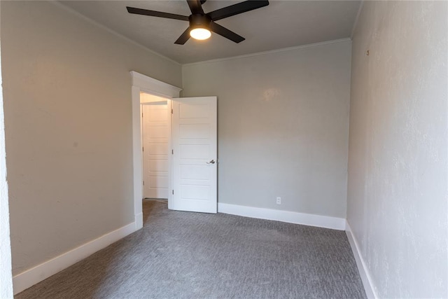 unfurnished room featuring dark carpet, ceiling fan, and ornamental molding