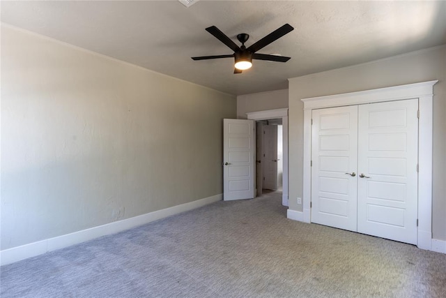 unfurnished bedroom featuring ceiling fan, a closet, and carpet