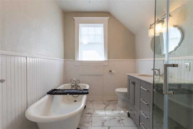 bathroom with a bath, vanity, toilet, and lofted ceiling