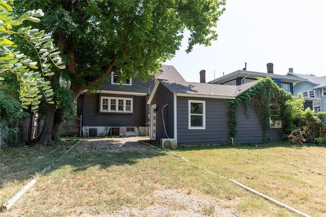 back of house with a lawn