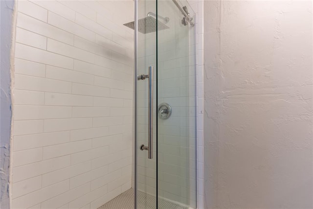 bathroom with a shower with shower door