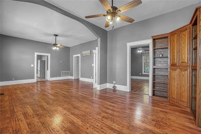 unfurnished living room with hardwood / wood-style flooring and ceiling fan