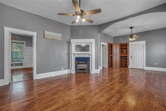 unfurnished living room featuring ceiling fan and wood-type flooring