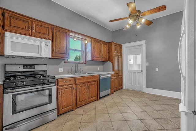 kitchen with ceiling fan, sink, light tile patterned flooring, and appliances with stainless steel finishes