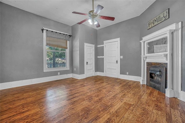 unfurnished living room featuring ceiling fan and hardwood / wood-style flooring