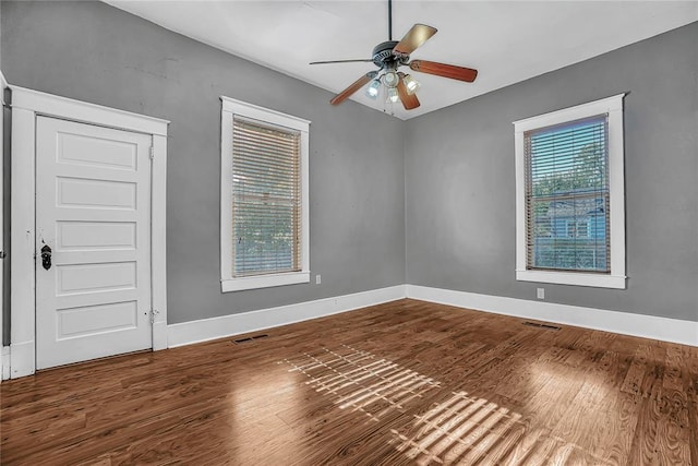 empty room featuring hardwood / wood-style flooring and a wealth of natural light