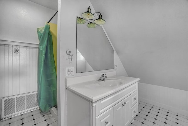 bathroom featuring a shower with curtain, vanity, tile patterned flooring, and vaulted ceiling