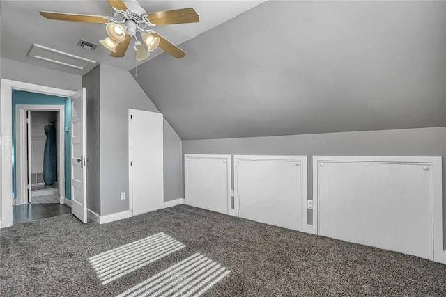 additional living space with dark colored carpet, vaulted ceiling, and ceiling fan