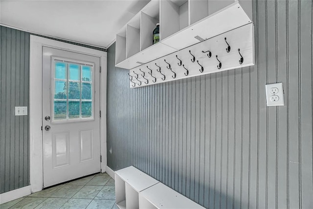 mudroom featuring wooden walls and light tile patterned floors