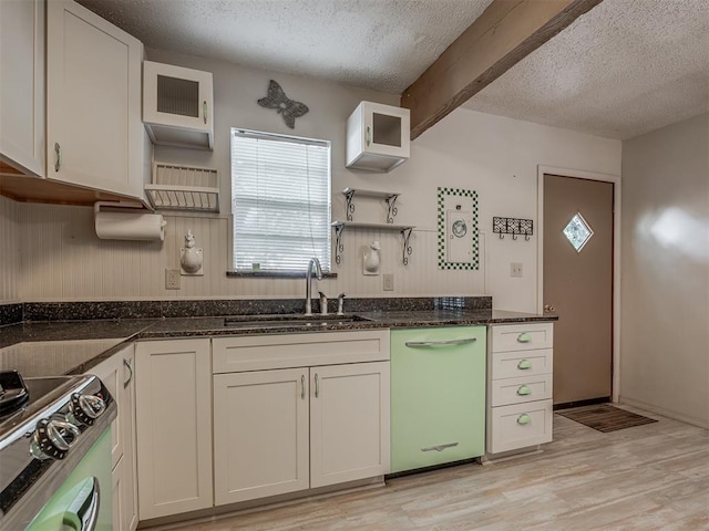 kitchen with white dishwasher, sink, light wood-type flooring, beamed ceiling, and white cabinetry