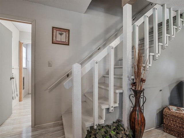 stairs featuring hardwood / wood-style floors