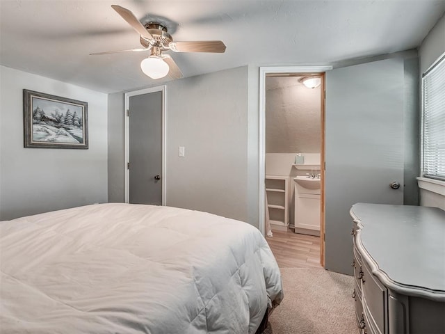 bedroom with connected bathroom, ceiling fan, sink, light hardwood / wood-style flooring, and a closet