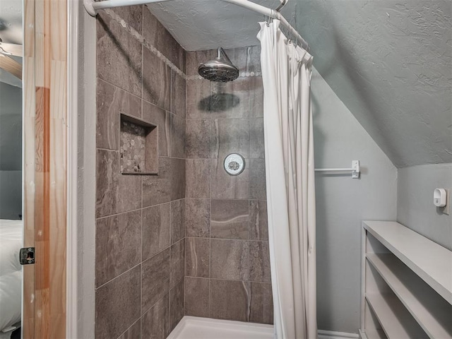 bathroom featuring vaulted ceiling and walk in shower