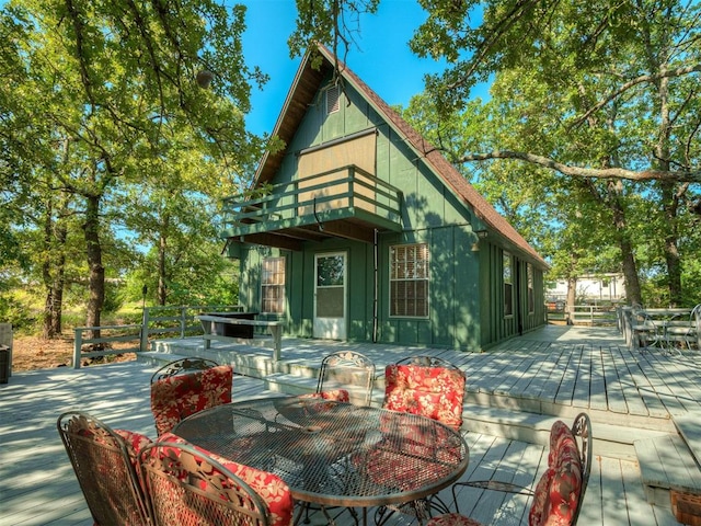 rear view of property with a balcony and a deck