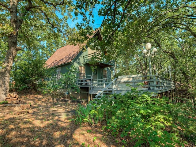 view of side of property with a wooden deck