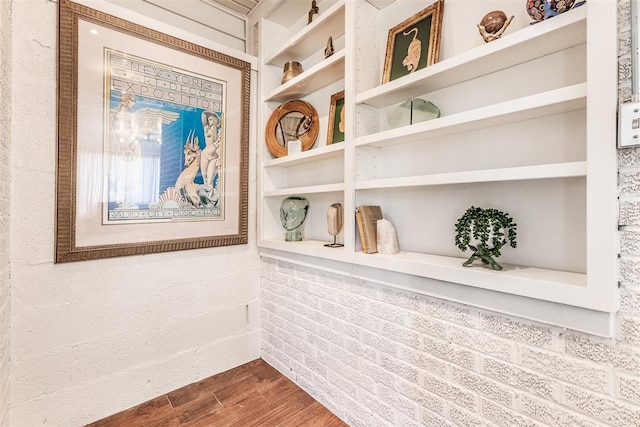 details featuring built in shelves and wood-type flooring