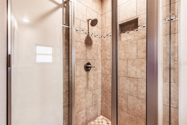 bathroom with a shower with shower door