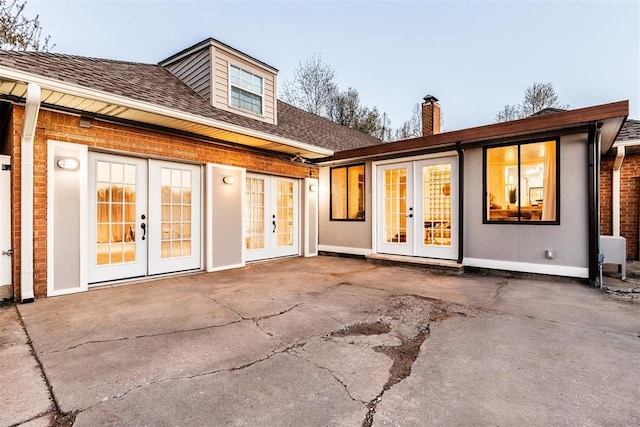 rear view of house with a patio area and french doors