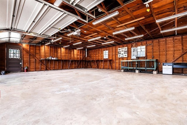 garage featuring a garage door opener and electric panel