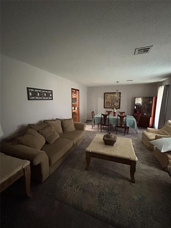 carpeted living room featuring a textured ceiling