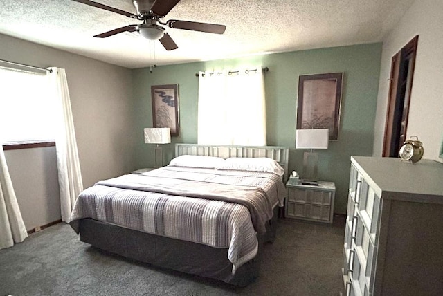 bedroom with dark colored carpet, a textured ceiling, and ceiling fan