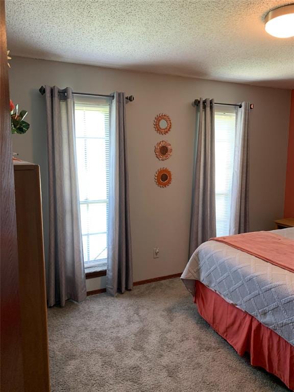 carpeted bedroom featuring a textured ceiling