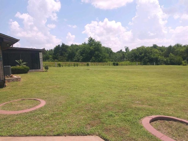 view of yard with central air condition unit