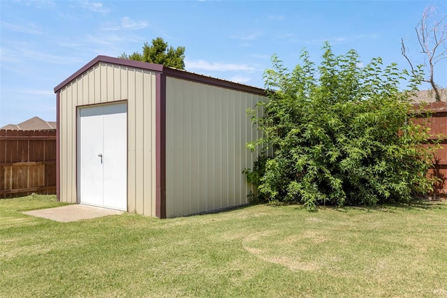 view of outbuilding with a lawn