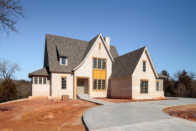 view of front of home with a shingled roof