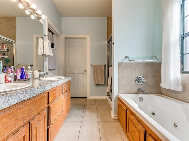 bathroom featuring tile patterned floors, vanity, and shower with separate bathtub