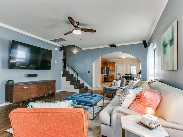 living room with dark hardwood / wood-style floors, ceiling fan, and ornamental molding