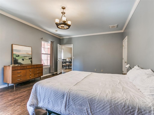 bedroom with a chandelier, dark hardwood / wood-style floors, and crown molding