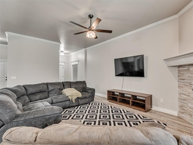 living room with hardwood / wood-style flooring, ceiling fan, and crown molding