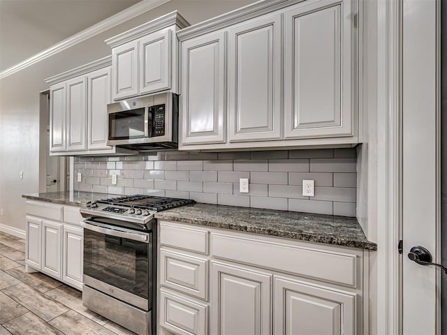 kitchen with tasteful backsplash, stainless steel appliances, crown molding, light hardwood / wood-style flooring, and white cabinets