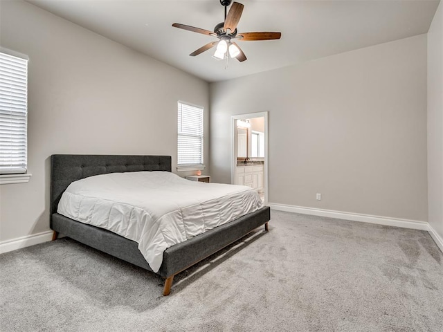 bedroom featuring carpet flooring, ensuite bathroom, and ceiling fan