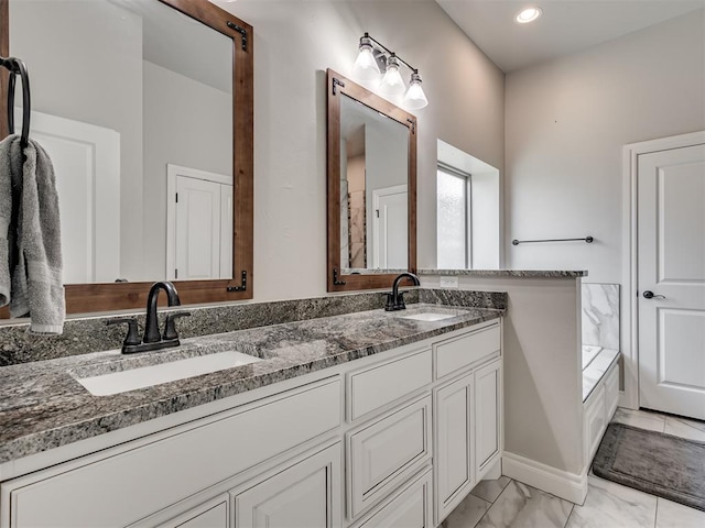 bathroom featuring vanity and a bath