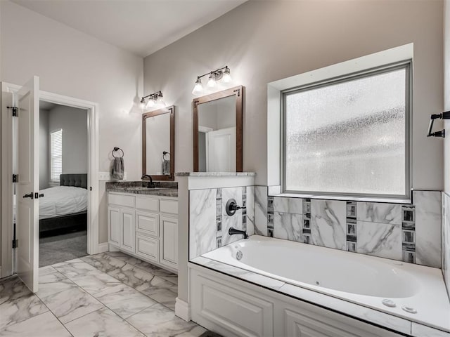 bathroom with vanity, a bathtub, and a wealth of natural light