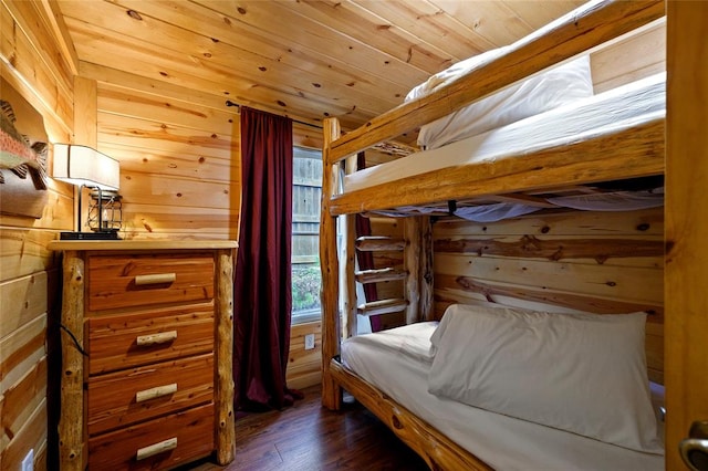 bedroom with wood walls, dark hardwood / wood-style flooring, and wooden ceiling