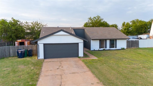 view of front of home featuring a garage and a front lawn