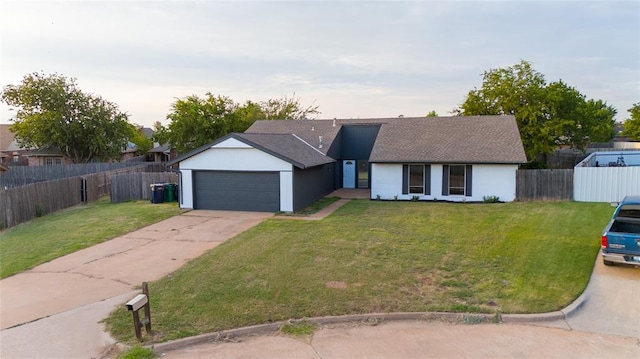 view of front facade with a yard and a garage