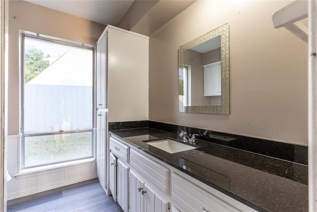 bathroom featuring hardwood / wood-style floors, vanity, and a textured ceiling