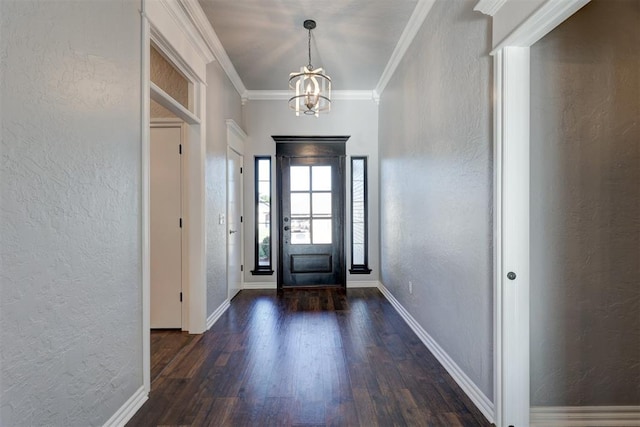 entrance foyer featuring dark hardwood / wood-style flooring, crown molding, and a chandelier