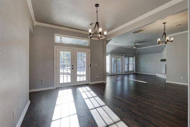 spare room with french doors, ceiling fan with notable chandelier, ornamental molding, and dark wood-type flooring