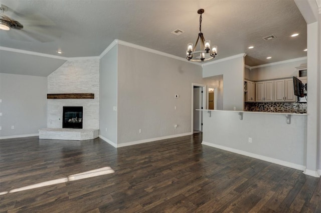 unfurnished living room featuring dark hardwood / wood-style flooring, a stone fireplace, and ornamental molding