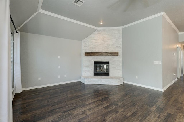 unfurnished living room featuring a stone fireplace, crown molding, dark hardwood / wood-style flooring, and vaulted ceiling