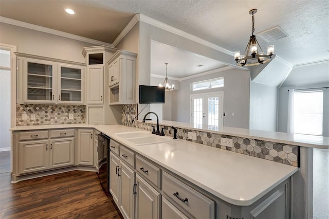 kitchen with sink, a healthy amount of sunlight, and an inviting chandelier