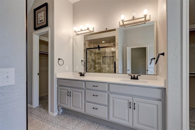 bathroom featuring tile patterned floors, vanity, and an enclosed shower